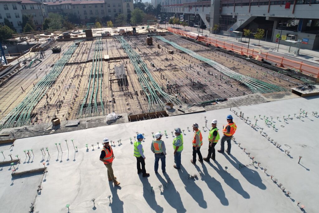 seven-construction-workers-standing-on-white-field-x-ghf9ljrvg