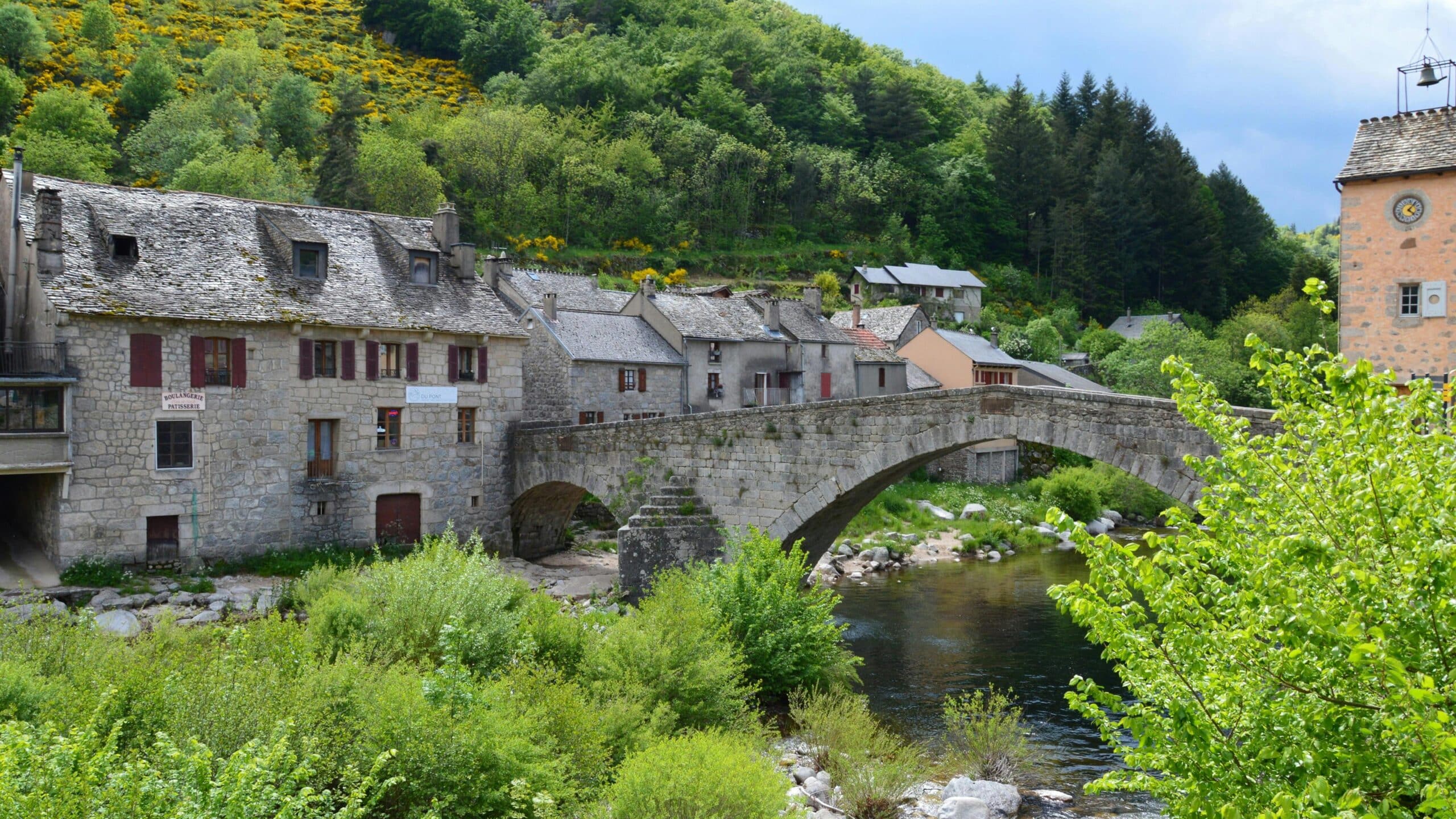 Scenic view of historic stone bridge and village in Pont de Montvert, France.